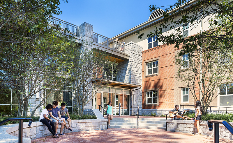 Oxford students sit outside a residence hall